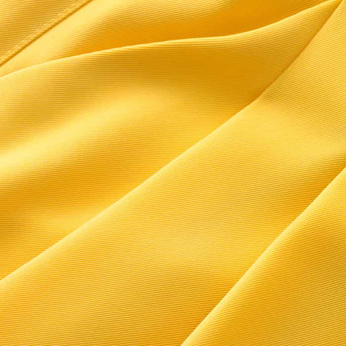 This heavy modern-twill tailoring drapes yet holds the shape of this jumpsuit. Created in our vibrant super lemon for a standout look with easy care properties.