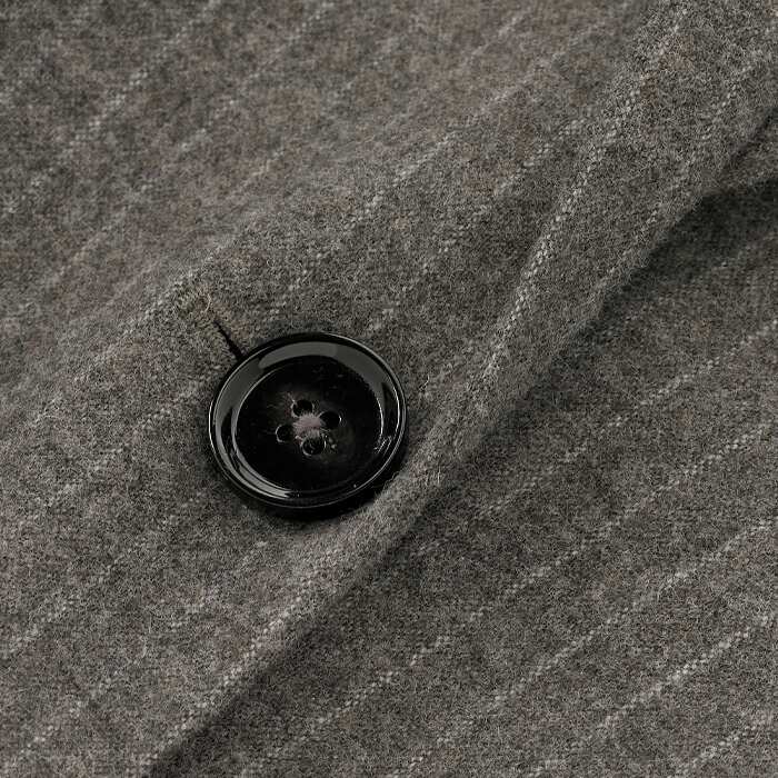 A faded chalk pinstripe on a supersoft brushed base gives this fabric a subtle menswear edge. 'Bleached Brown' wool-blend base acts as a versatile neutral to be worn dressed up or down. Fully lined for comfort with a modern black button.