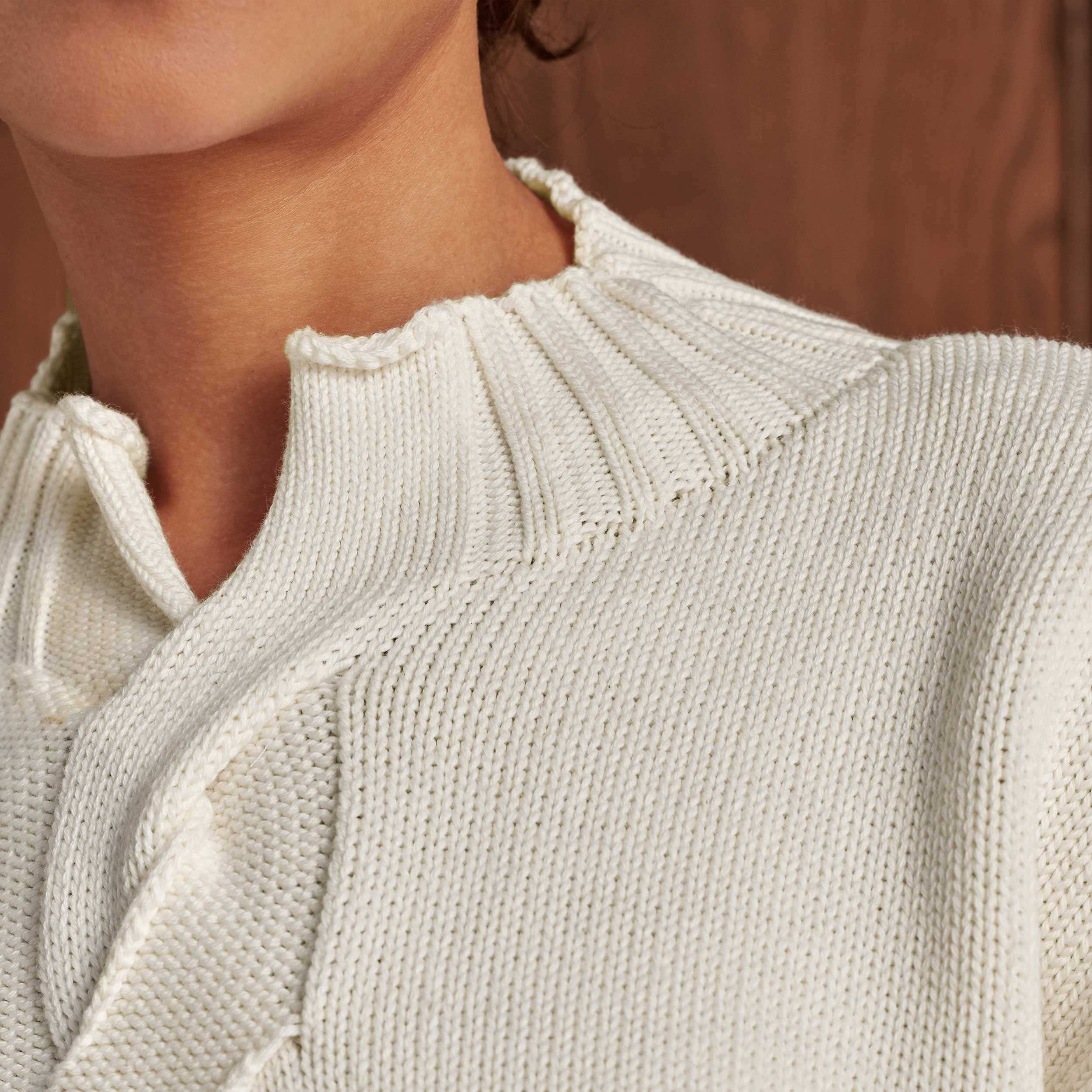 The grown-on, high ribbed neck with front vent opening offers an alternative to a full polo neck design.