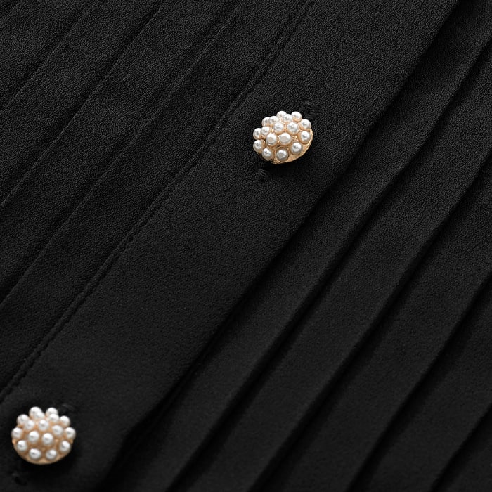 Fluid crepe woven in a classic black, this fabric is crease resistant and will never fade or pill. Features statement jewel buttons for a luxury edge.