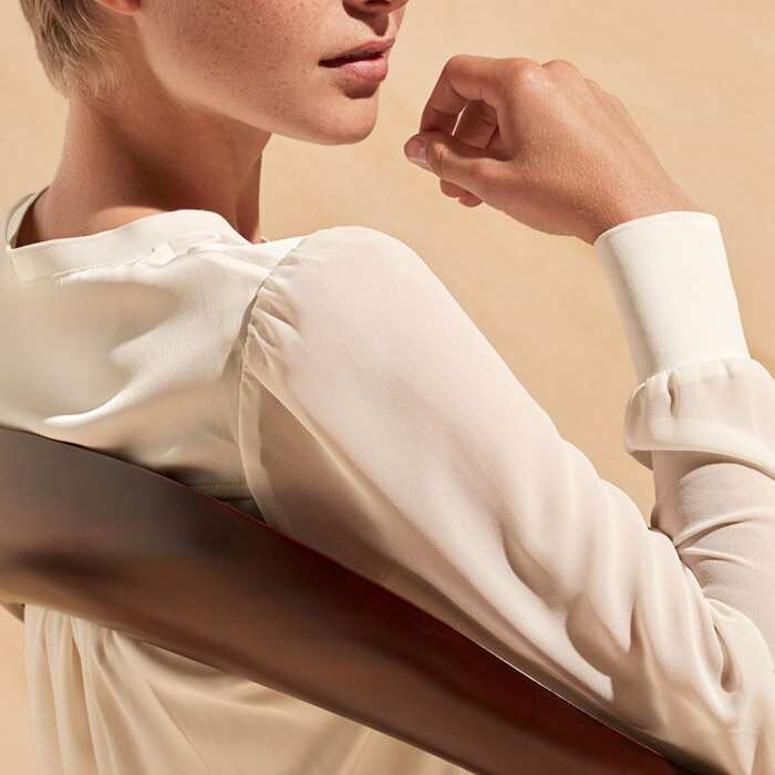 Flattering sheer sleeves show just the right amount of reveal.

